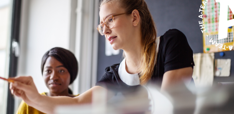 Two-businesswomen-at-an-office-desk-in-a-meeting
