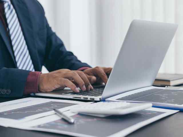 close up of a man working on his laptop