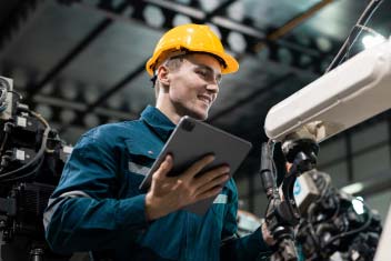 man in factory in front of the robot