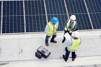 Engineering solar panel and top view of team in discussion for inspection or installation
