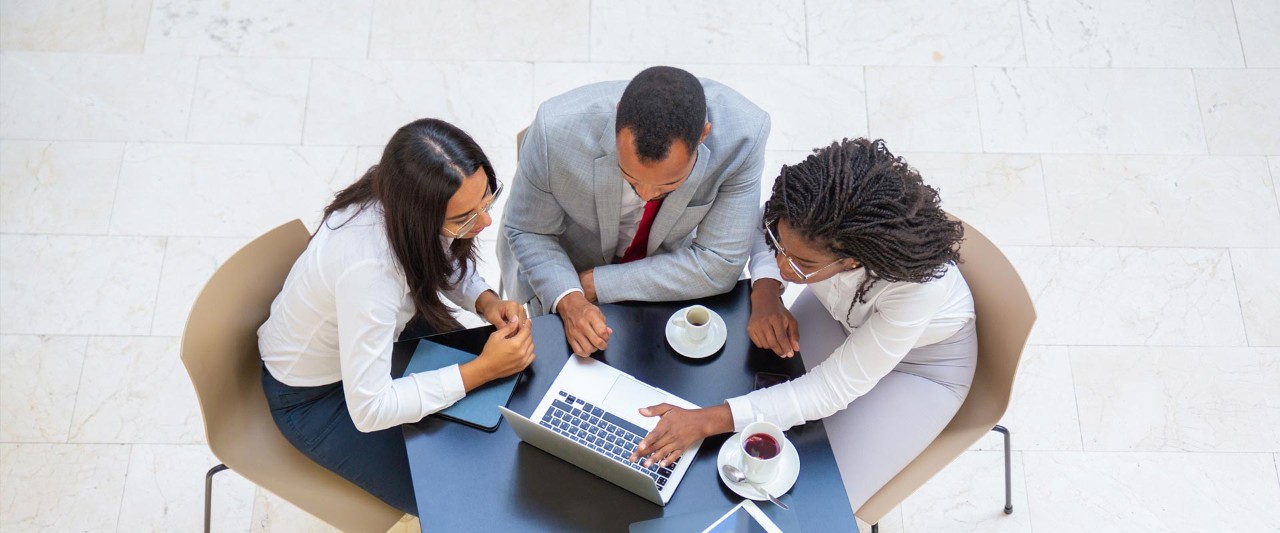 Diverse team working on project during coffee break