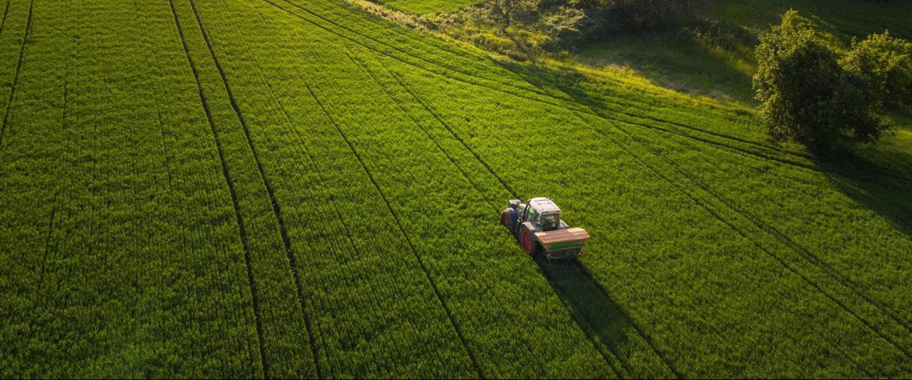 tractor driving through a field