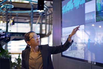 woman ponting on presentation screen
