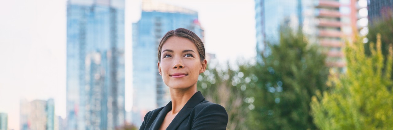 a woman standing in front of buildings