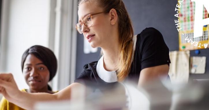 Two-businesswomen-at-an-office-desk-in-a-meeting