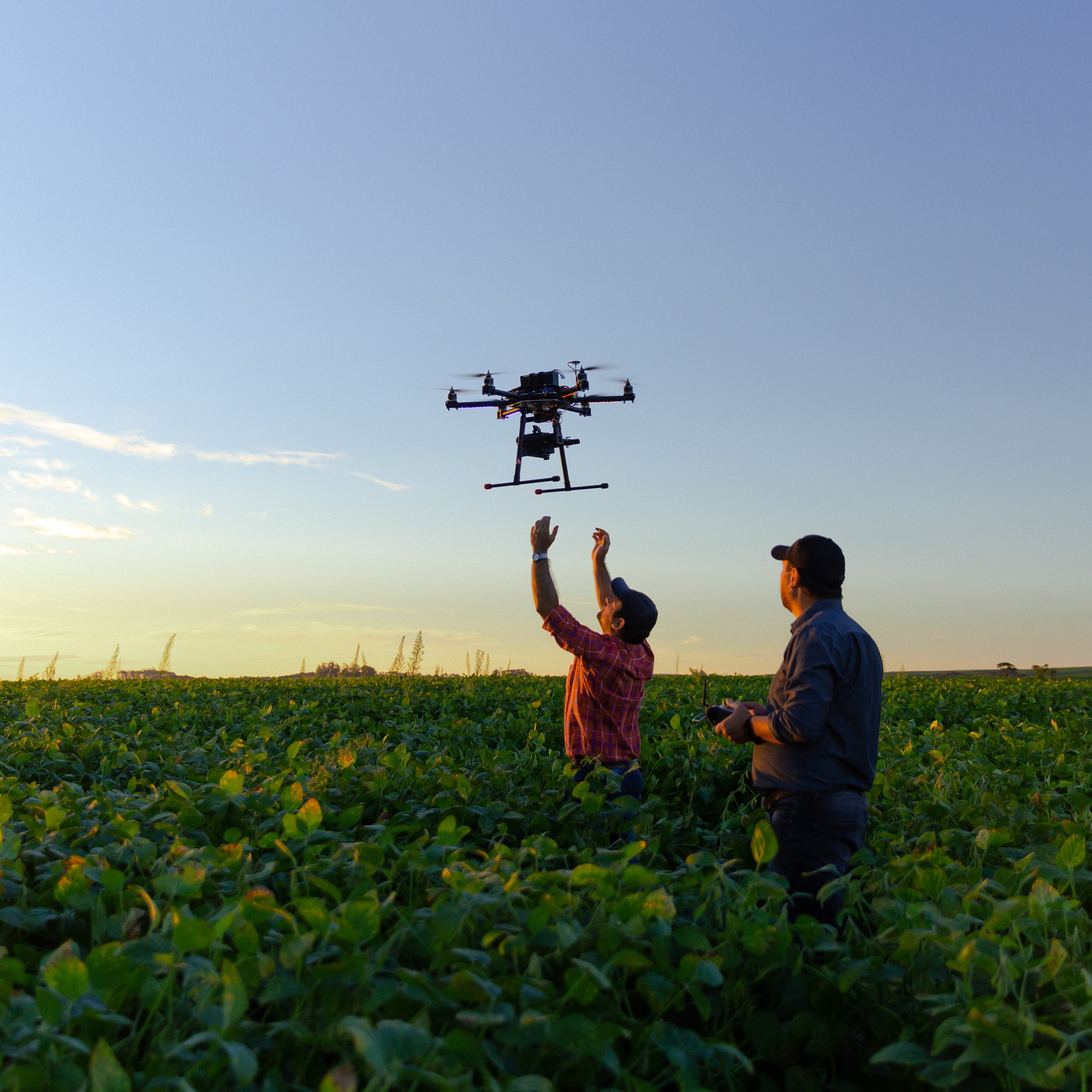 two men with drone being launched