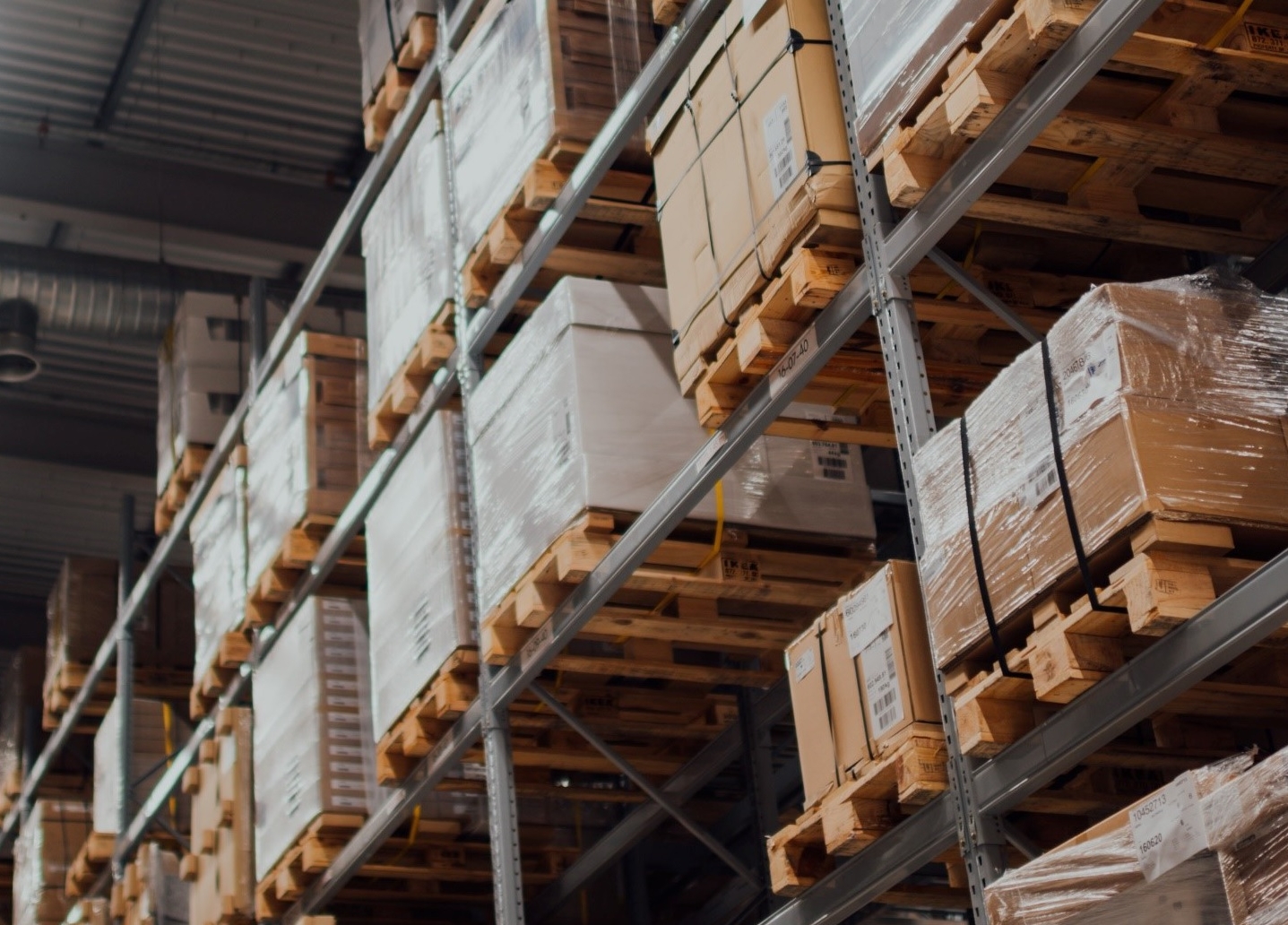 storage warehouse with pallets of boxes stacked on racks