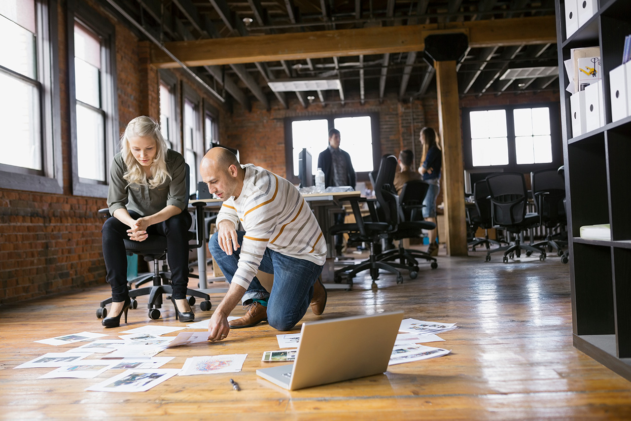 man and woman kneeling down looking towards floor