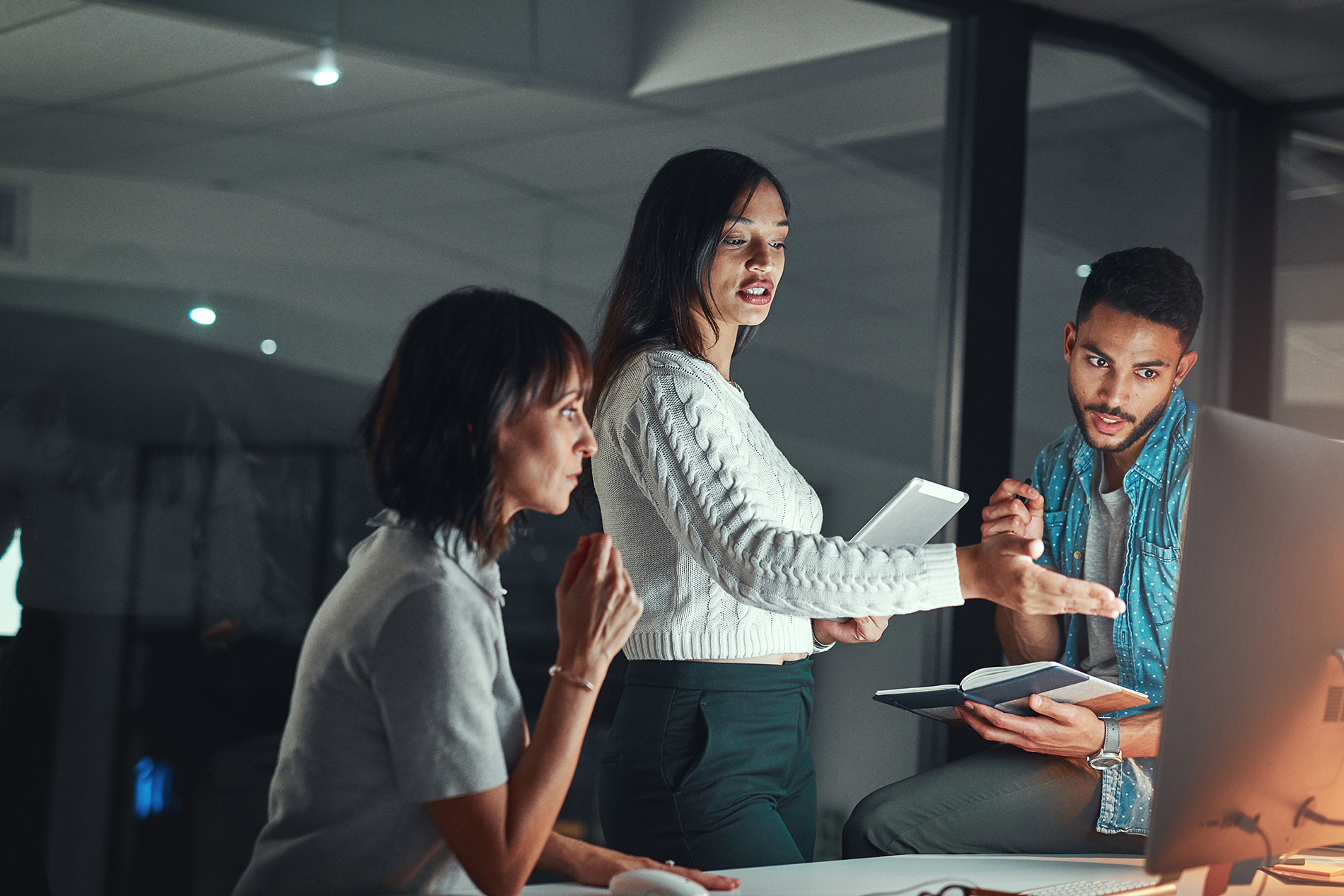 three co-workers Reviewing Credit Risk Data