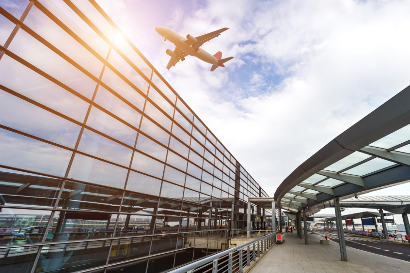 A plane flying above an airport